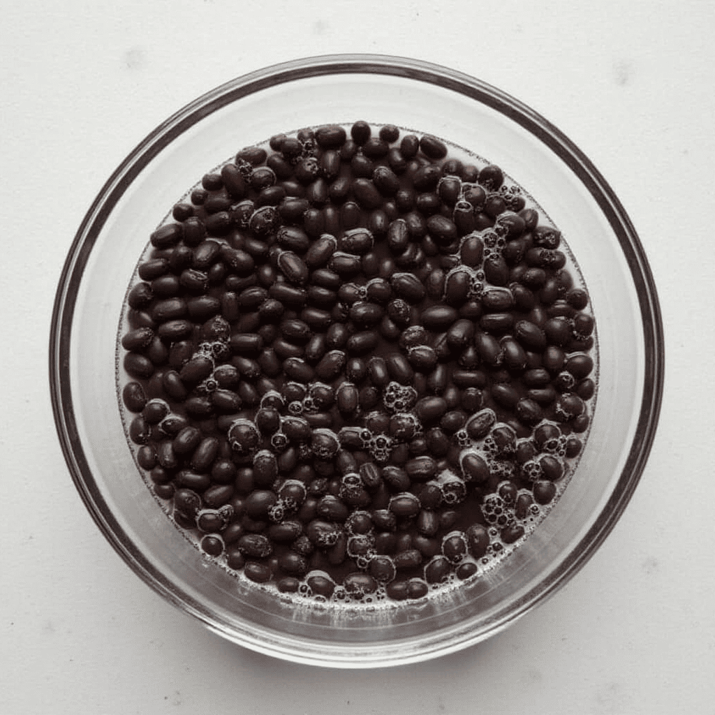 Black beans soaking in water to remove bitterness.