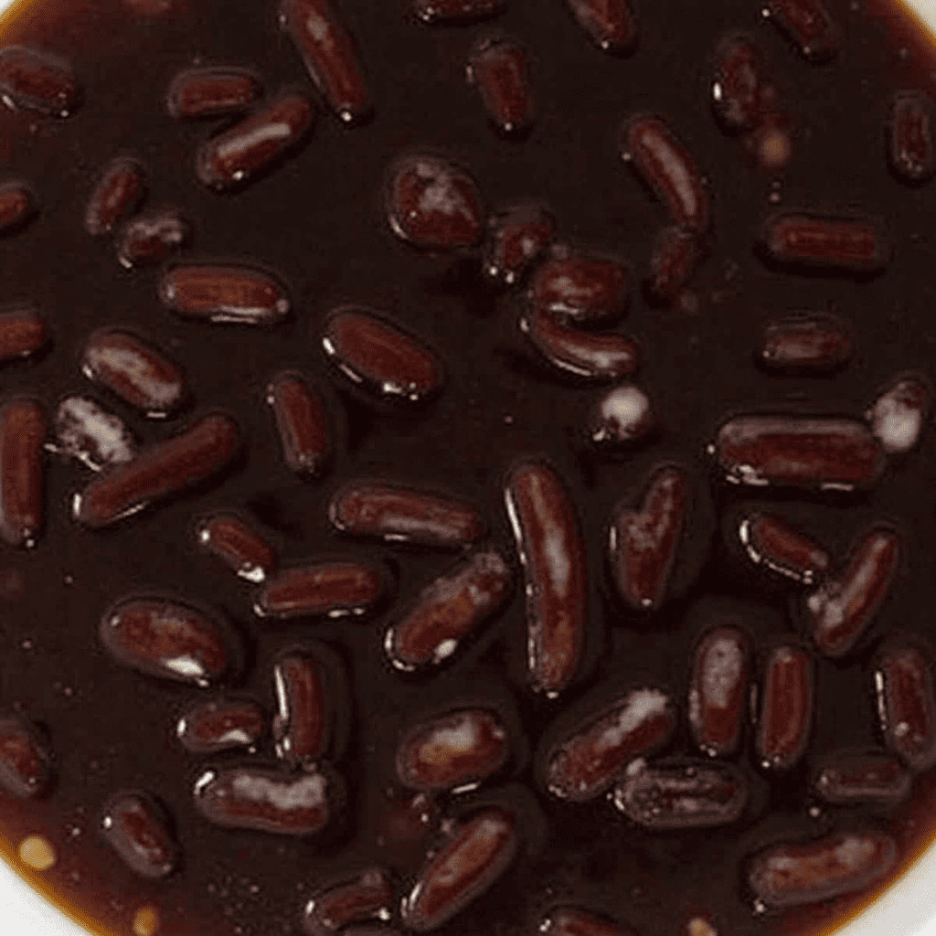 A can of black beans with visible liquid brine.